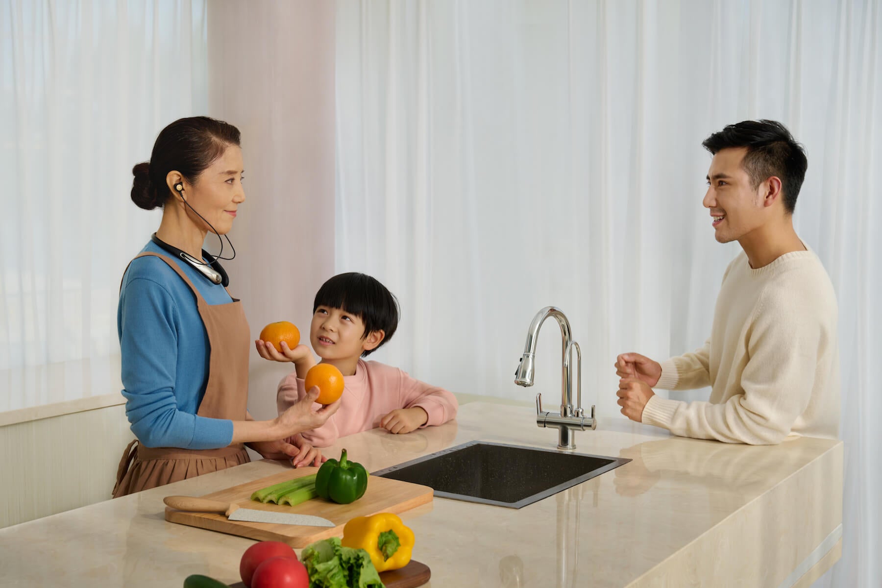 Woman wearing Kite 2 Smart Personal Sound Amplifier in conversation with family members