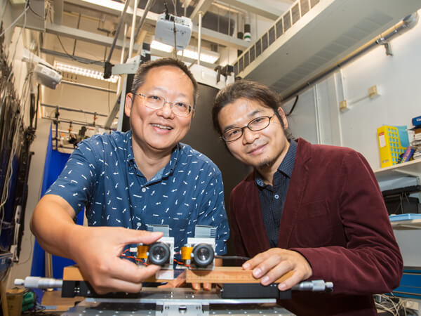 Professor Richard So and Calvin Zhang showcasing a prototype