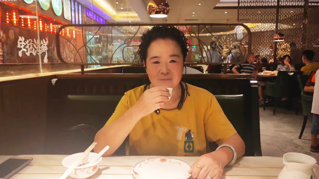 Mrs Wang wearing Kite 2 in a restaurant