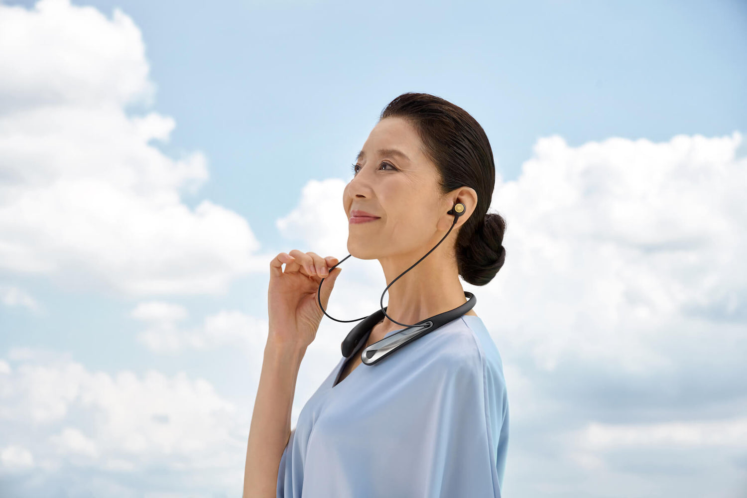 Woman wearing Kite 2 smart personal sound amplifier