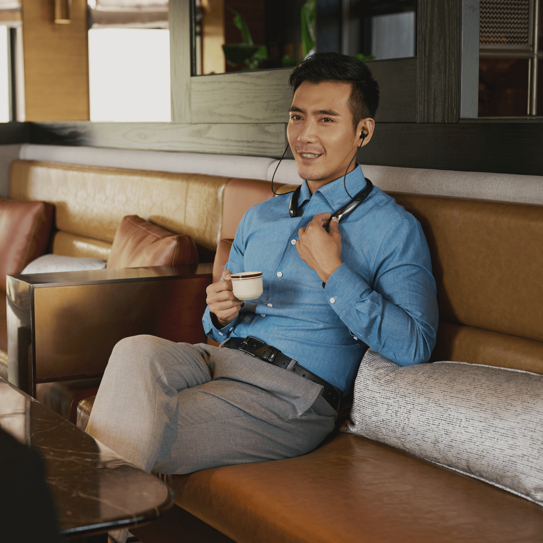 Man engaging in conversation while wearing the latest Incus hearing assistance device