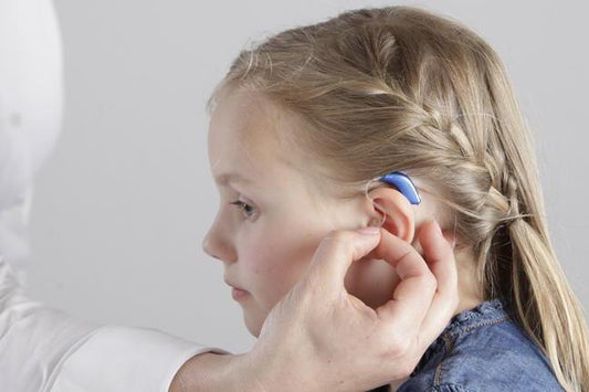 Child with Usher Syndrome wearing hearing aid