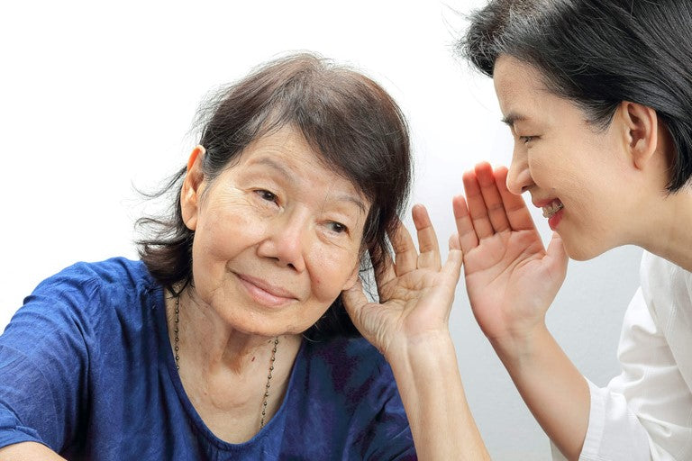 Woman with hearing loss without hearing aids has difficulties hearing