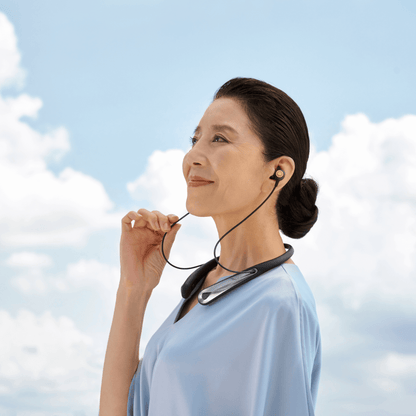 Woman happy wearing Kite 2 hearing aid